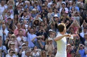 Andy Murray of Britain throws his wristbands into the crowd after defeating Mikhail Youzhny of Russia in their men's singles tennis match at the Wimbledon Tennis Championships, in London